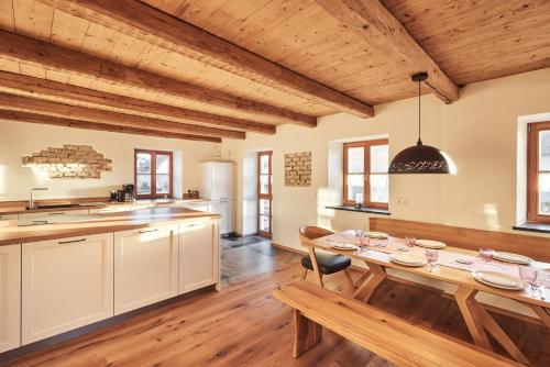 a kitchen and dining room with a wooden table at Haus Herzbluat in Peiting