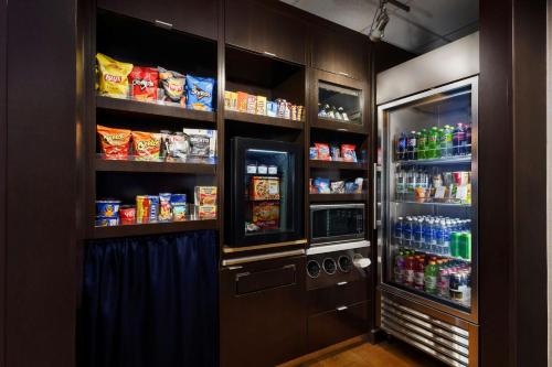 a kitchen with a refrigerator with food and drinks at Courtyard By Marriott Salinas Monterey in Salinas
