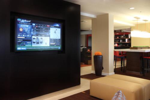 a living room with a flat screen tv on a wall at Courtyard By Marriott Salinas Monterey in Salinas