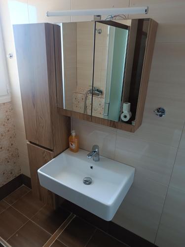 a bathroom with a white sink and a mirror at Assos Beach in Káto Ássos