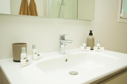 a bathroom with a white sink with a mirror at Casa Olivia - By AZ Rentals in Playa Blanca