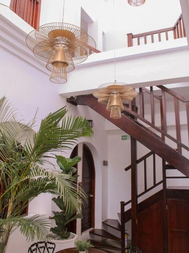 two chandeliers hanging from the ceiling in a building at Hotel Casa Agustina in Cartagena de Indias
