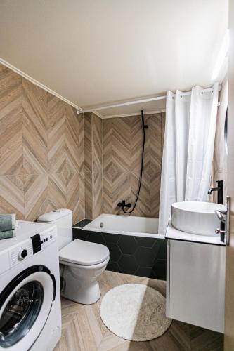 a bathroom with a toilet and a washing machine at Ariadnes cosy apartment- walk everywhere in Alexandroupoli