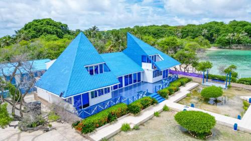 an aerial view of a blue house with a blue roof at Hotel Rosario de Mar by Tequendama in Isla Grande