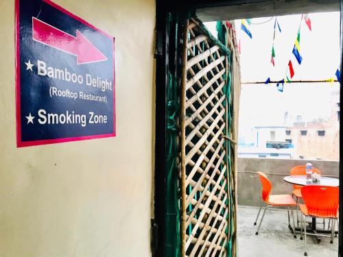 a sign on a wall next to a table with chairs at Hampton Hotel - 200 mt from Golden Temple in Amritsar