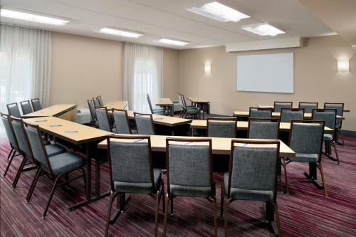 a conference room with tables and chairs and a whiteboard at Courtyard by Marriott Raleigh Cary in Cary