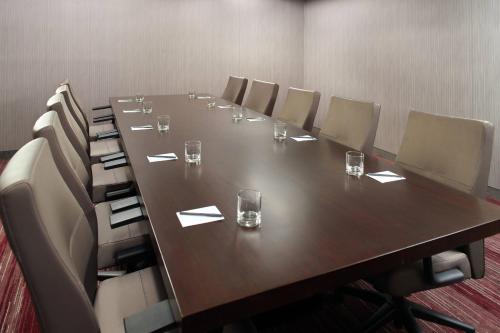 a conference room with a long wooden table and chairs at Courtyard by Marriott Raleigh Cary in Cary
