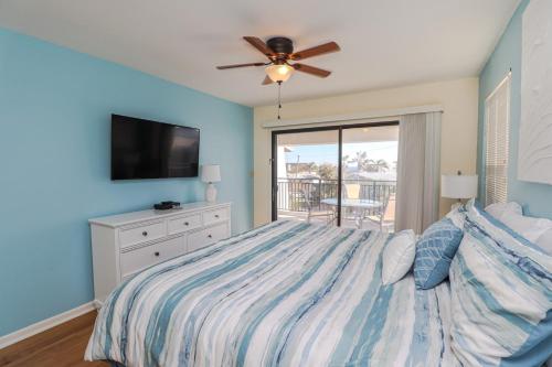 a bedroom with a bed and a ceiling fan at Island South 36 in Saint Augustine
