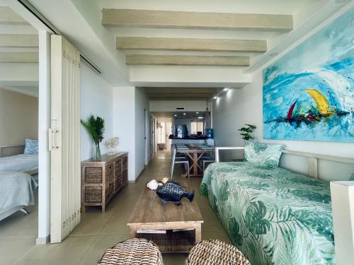 a living room with a couch and a painting on the wall at Bay Point- Ocean View Apartments by NIDHO PROPERTIES in San Andrés