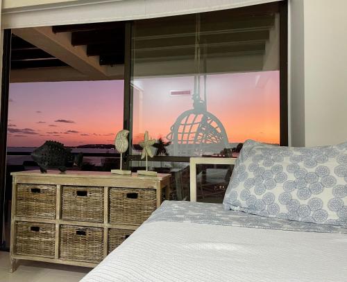 a bedroom with a bed and a view of the ocean at Bay Point- Ocean View Apartments by NIDHO PROPERTIES in San Andrés