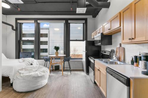 a kitchen and living room with a bed and a table at Downtown Spokane Studio Walkable & Secure Stay in Spokane