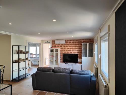 a living room with a couch and a brick wall at Seaside Beach-Lounge Alicante in El Campello