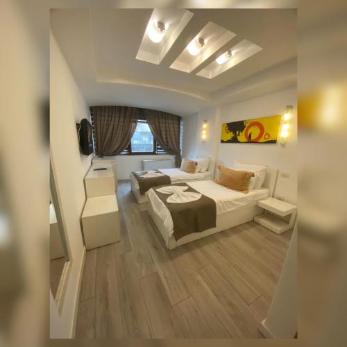a hotel room with a bed and a desk at Theranda Hotel in Prizren