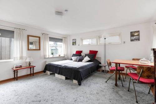 a bedroom with a bed and a table in it at Authentic Dutch Houseboat in Amsterdam Zuid in Amsterdam