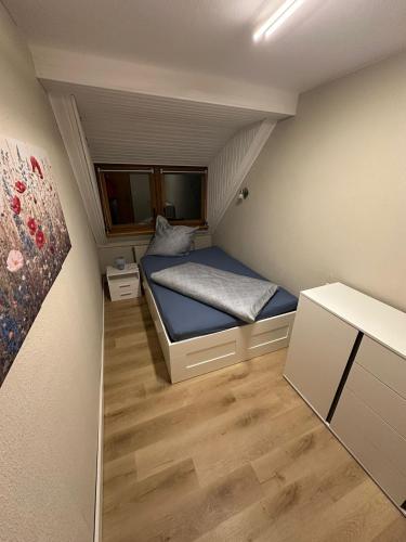 a small bedroom with a bed in a small room at Apartment Dobias in Kelberg
