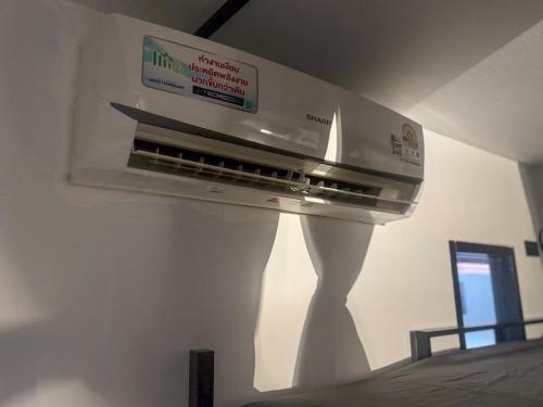a kitchen with a stove top oven in a room at Nordic Hostel & Gym l Female Only in Phi Phi Don