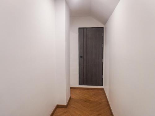 a hallway with a door in a white wall at Nordic Hostel & Gym l Female Only in Phi Phi Don