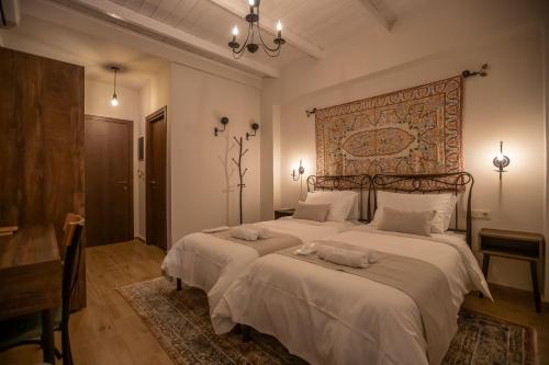 a bedroom with a large bed with a large headboard at Ξαπόσταμα XAPOSTAMA - Ενοικιαζόμενα Δωμάτια in Kalyvia