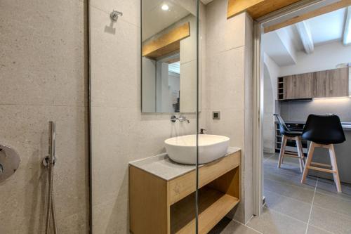 a bathroom with a sink and a glass shower at Villa Lefkothea in Georgioupoli