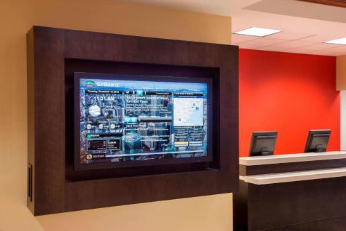 a television on a wall in a room at Courtyard by Marriott Toronto Airport in Toronto