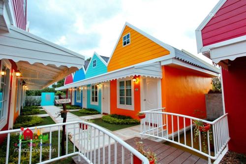 a group of houses painted in different colors at Color Ville Hotel SHA Certified in Sakon Nakhon