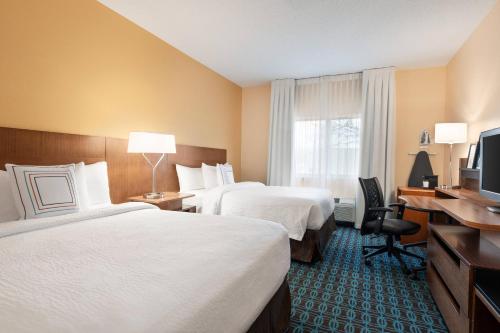 a hotel room with two beds and a television at Fairfield Inn by Marriott Deptford in Deptford