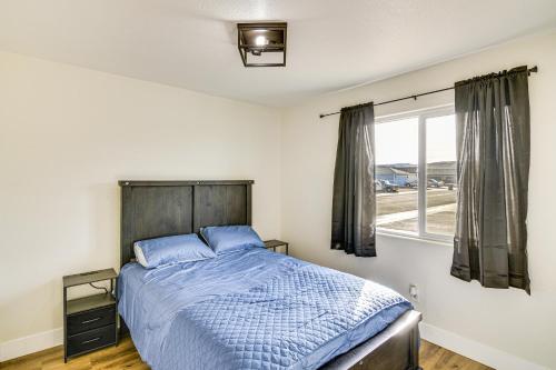 a bedroom with a bed and a window at 1 Mi to Pioneer Crossing Casino Fernley Retreat! in Fernley