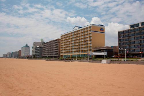 a sandy beach with buildings in the background at Fairfield Inn & Suites by Marriott Virginia Beach Oceanfront in Virginia Beach
