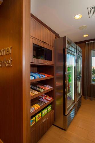 a refrigerator in a kitchen with food inside of it at Fairfield Inn and Suites by Marriott Tifton in Tifton