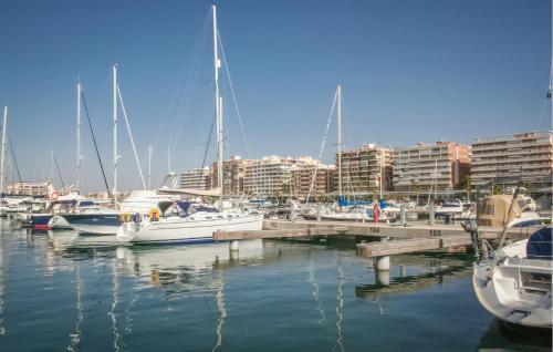 a group of boats docked in a marina with buildings at Amazing Apartment In Santa Pola in Santa Pola