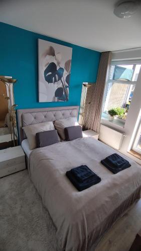 a bedroom with a large bed with two towels on it at Liptovská Panoráma in Liptovský Mikuláš
