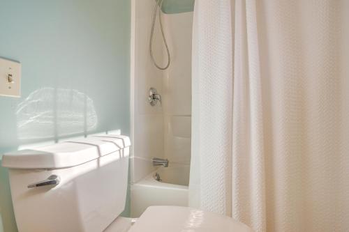 a bathroom with a toilet and a shower curtain at Walk to Grays Beach Park Kingston Seaside Escape in Kingston