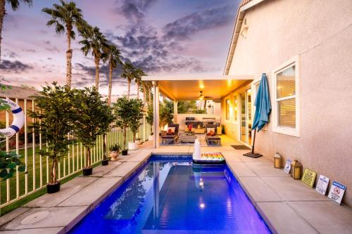 a swimming pool in the backyard of a house at Music Lovers Paradise 7 Bed Pool Home and Game Room in Indio