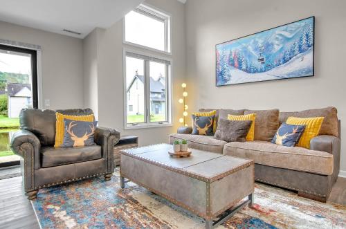 a living room with two couches and a coffee table at Family townhouse with Fireplace in Ellicottville