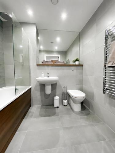 a bathroom with a toilet and a sink and a shower at The Panda - Modern 2 Bedroom Apt in Manchester City Centre in Manchester