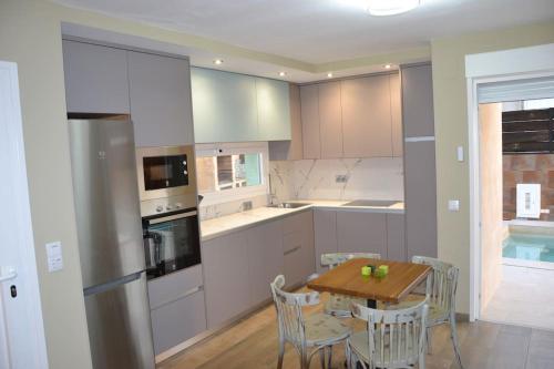 a kitchen with a wooden table and a dining room at El huerto de la Dominga in Segovia
