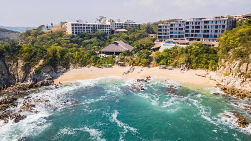 an aerial view of a beach with buildings at Coral Blue Huatulco All Inclusive in Santa Cruz Huatulco