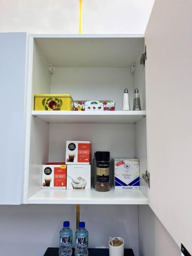 a pantry with medicines and other items on shelves at LUMAX Studio in Gryfice