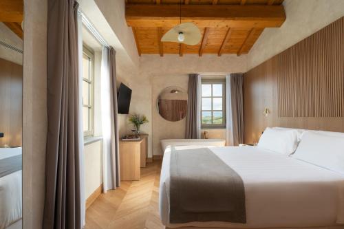 a bedroom with a large white bed in a room at Villa Petriolo - Small Luxury Hotels of the World in Cerreto Guidi