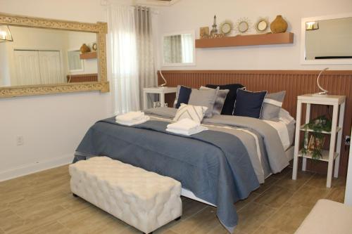 a bedroom with a large bed and a mirror at Casa Maria Bonita in McDonough