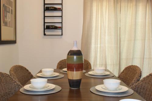 a table with cups and a vase on top of it at Casa Maria Bonita in McDonough