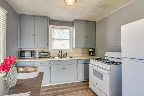 a kitchen with white cabinets and a white stove top oven at Near Sabine Lake Pet-Friendly Apt in Port Arthur in Port Arthur