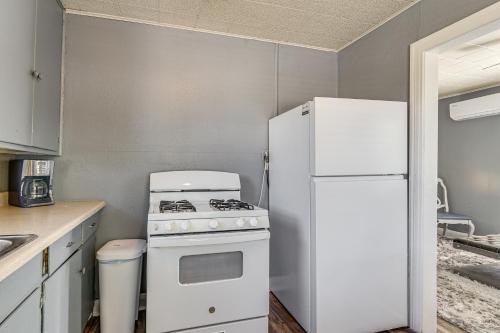 a kitchen with a white stove and a refrigerator at Near Sabine Lake Pet-Friendly Apt in Port Arthur in Port Arthur