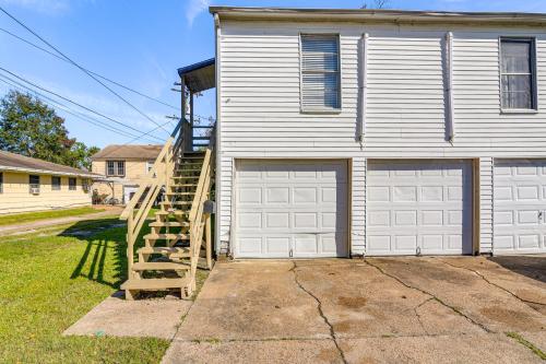 a house with two garage doors and a wooden staircase at Near Sabine Lake Pet-Friendly Apt in Port Arthur in Port Arthur