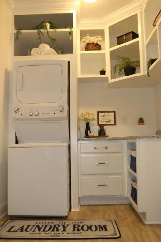 a kitchen with a white refrigerator and a laundry room at Casa Maria Bonita in McDonough