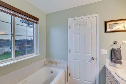 a bathroom with a tub and a sink and a window at 6 Mi to Dtwn Lewiston Quiet Home with Views in Clarkston