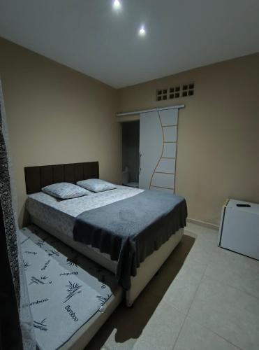 a bedroom with a bed in a room with a ladder at Pousada chc in Praia Grande