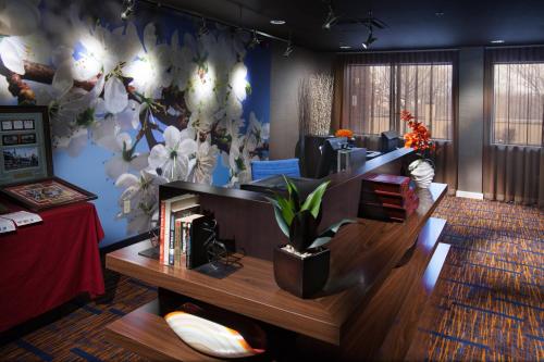 a living room with a flower mural on the wall at Courtyard by Marriott Fayetteville in Fayetteville