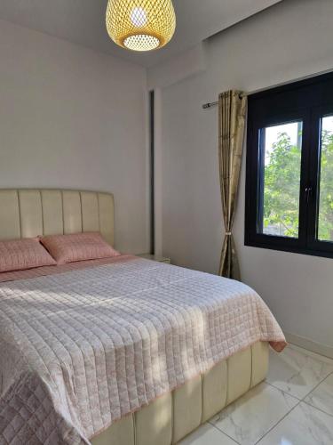 a bedroom with a bed and a window at Villa Elia in Aígio