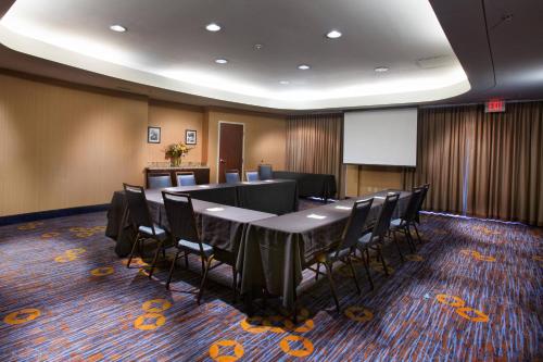 a conference room with a long table and chairs at Courtyard by Marriott Fayetteville in Fayetteville